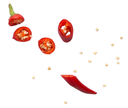 Sliced red chili pepper with scattered seeds.