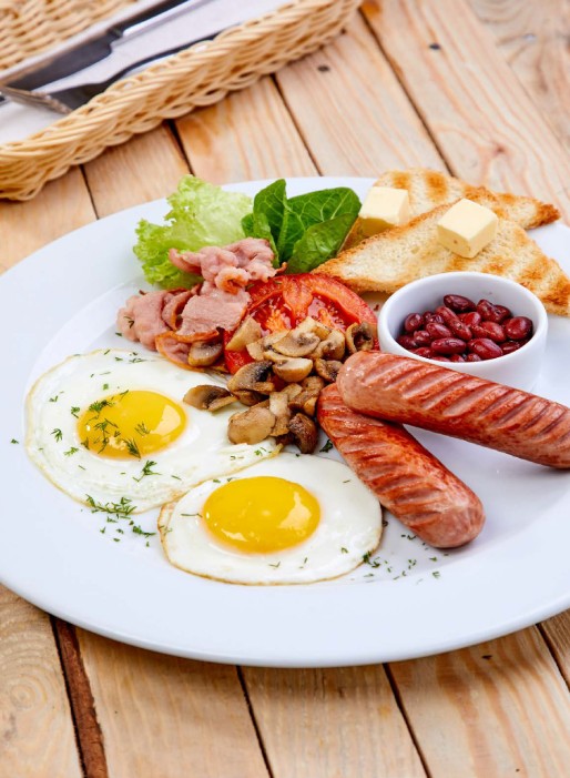 Hearty breakfast with eggs and sausages.