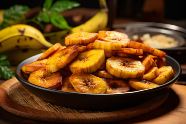 Fried plantains on a dark plate.