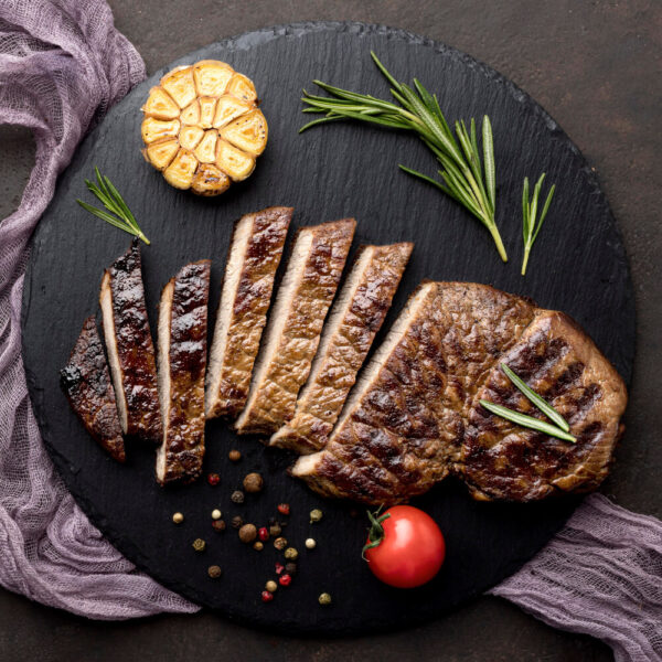 Grilled steak slices with herbs and garlic.