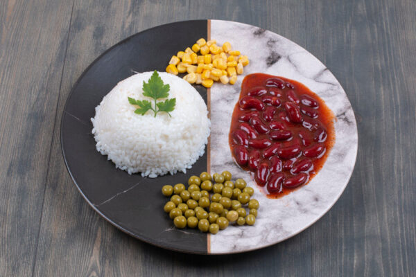 Rice, beans, corn, and peas on plate.