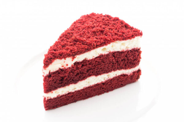 Red velvet cake slice on plate.